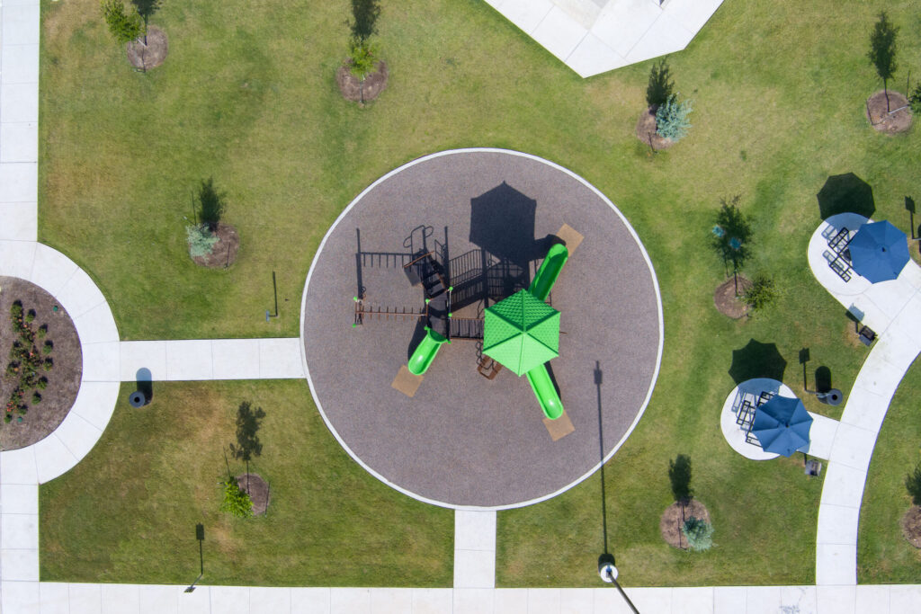 drone shot of playground at Pecan Grove apartments